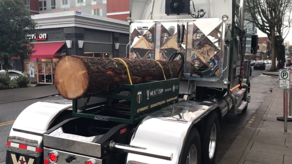 Polished door enclosure on semi-truck hauling a log