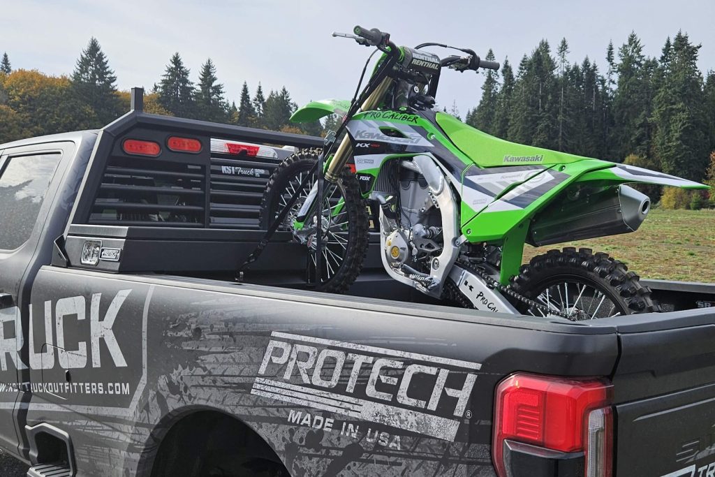 Motocross bike secured by Motocross truck toolbox